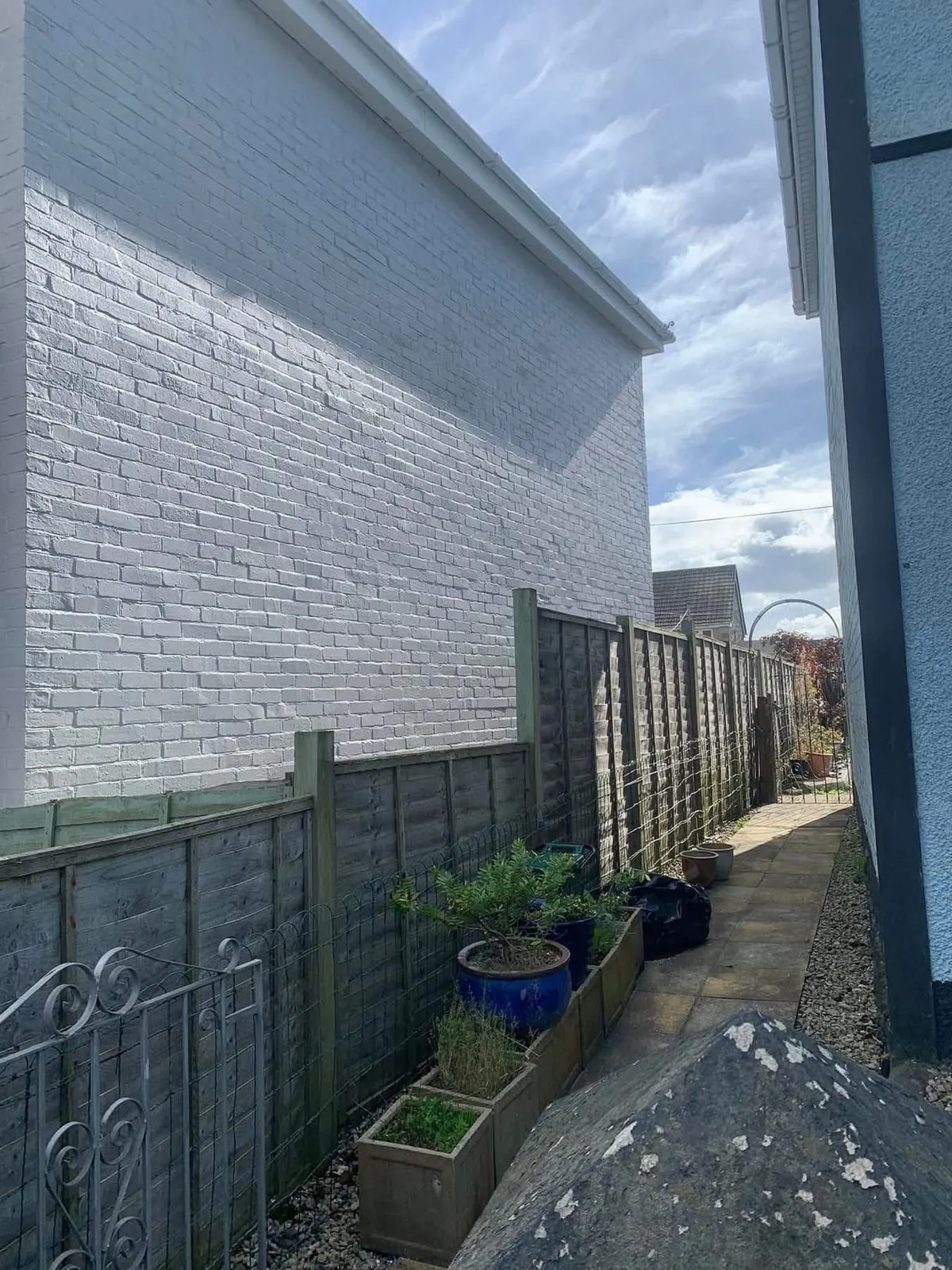 Freshly painted brick wall after preparation and masonry paint in Ilfracombe